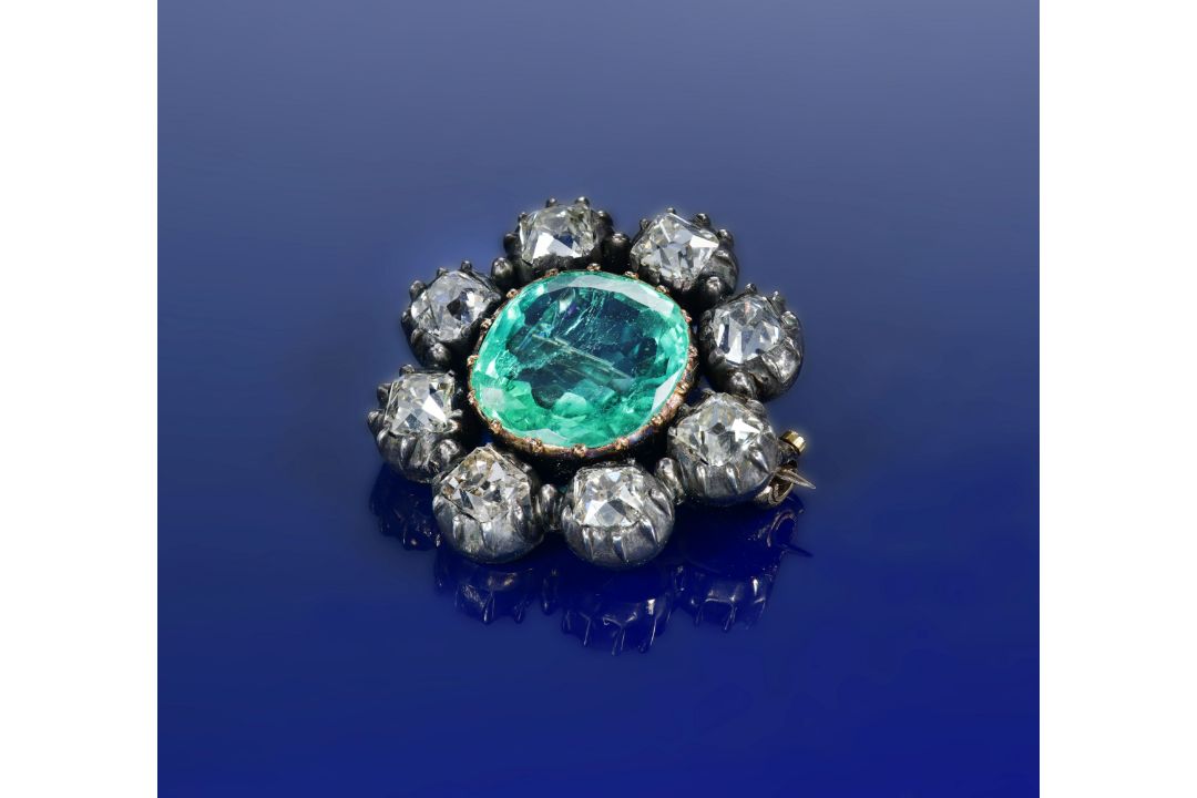 An early Victorian brooch set with a cushion cut emerald of approximately 4.2ct surrounded by - Image 1 of 3