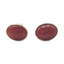 A PAIR OF VINTAGE 18CT GOLD AND CARNELIAN STUD EARRINGS Cabochon cut stones. (approx 1cm x 0.5cm,