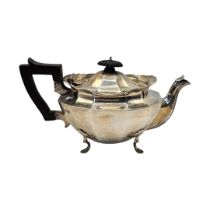 AN EARLY 20TH CENTURY HALLMARKED SILVER TEAPOT Having scrolled decoration and chamfered body. (