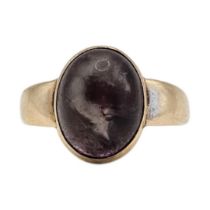 A VINTAGE 9CT GOLD AND AMETHYST RING Cabochon cut stone in a wide band. (approx 4.8g, size Q)
