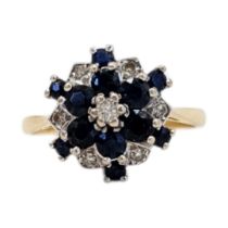 A VINTAGE 18CT GOLD, SAPPHIRE AND DIAMOND CLUSTER RING Having an arrangement of round cut stones