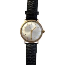 GARRARD, A VINTAGE 9CT GOLD GENTS WRISTWATCH Silver tone with gilt number markings, on a black