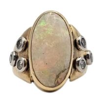 A VINTAGE 18CT GOLD, OPAL AND DIAMOND RING The central oval cut opal flanked with round cut