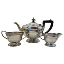 AN EARLY 20TH CENTURY SILVER THREE PIECE TEASET Circular form, with brown Bakelite handles