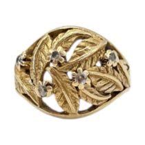 A CONTINENTAL YELLOW METAL AND DIAMOND CLUSTER RING Having an arrangement of round cut diamonds