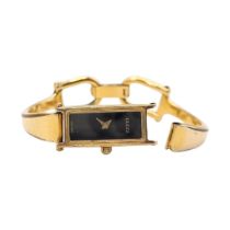 GUCCI, A GOLD PLATED LADIES BANGLE WRISTWATCH Rectangular black tone dial, marked to reverse