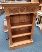 PINE OPEN BOOKCASE WITH CARVED DECORATION ON PLINTH BASE,