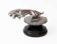 A 1940's Chrome Jaguar Car Mascot, mounted on an original radiator cap on a black ceramic circular