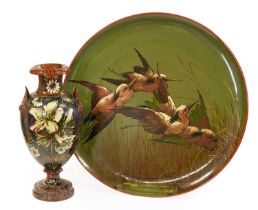 A Watcombe Pottery Vase, painted with a sunflower and white lilies, on a stippled ground, black