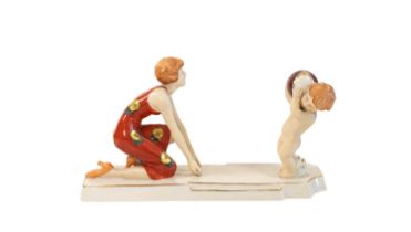 A Royal Dux Art Deco Figural Group, modelled as a kneeling mother with her infant holding a ball, on