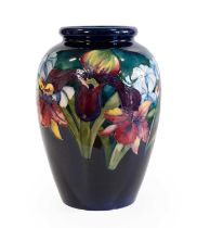 Walter Moorcroft (1917-2002): An Orchid and Spring Flowers Vase, on a blue ground, impressed