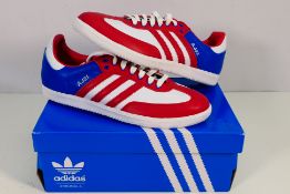 Adidas - A pair of trainers in red, white and blue, UK size 9 contained in Adidas shoe box.