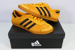 Adidas - A pair of Hamburg trainers in orange and black, UK size 9 and contained in Adidas box.