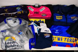 Six Leeds Rhinos shirts / jackets, sizes L, XL and 3XL. Generally good condition with some wear.