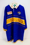 A Leeds Rhinos Asics rugby shirt bearing multiple signatures, size XL.