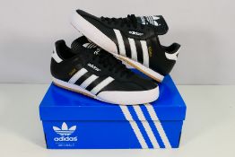 Adidas - A boxed pair of Samba Super trainers in black, UK size 9½, contained in original box.