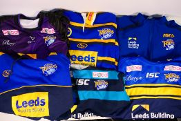 Six Leeds Rhinos shirts / tops, sizes XL and 2XL. Generally good condition with some wear in areas.