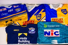 Five Leeds Rhinos shirts, sizes XL, XXL and 2XL. Generally good condition with some wear in areas.