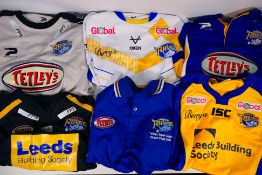 Six Leeds Rhinos shirts, stated sizes L and 2XL. Generally good condition with some wear to some.