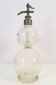 A Boots Cash Chemist double gourd soda syphon with embossed pewter spout, 50 cm (h).