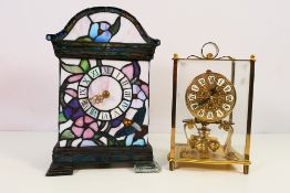 Two clocks comprising a Kundo torsion clock and a Tiffany style mantel clock with illumination,