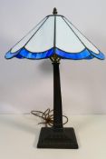 A Tiffany style table lamp with square section stem
