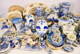 A large collection of various Delft wares to include money banks, tankards, candlesticks,