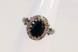 A white metal (stamped 18ct) sapphire and diamond ring, size O½, approximately 4 grams.