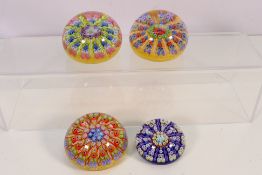 Four millefiori paperweights, largest approximately 8 cm (d).