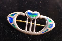 An Art Nouveau silver and enamel brooch by Charles Horner,