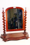 A mahogany framed toilet mirror with Solomonic column supports, approximately 60 cm x 60 cm x 24 cm.