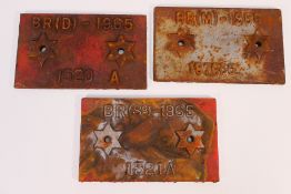 Three cast iron wagon plates, two 1965 and one 1966.