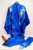 A vintage Japanese kimono with floral and foliate decoration and a floral decorated parasol. [2].