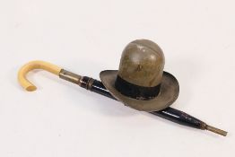 A travelling inkwell and dip pen in the style of a 10 gallon hat and umbrella, circa 1890.