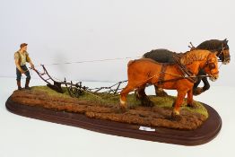 A large limited edition farming diorama depicting two working horses pulling a plough,