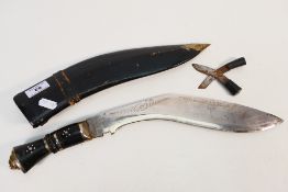 Khukri knife with decoration including 'India' to the blade also 2 smaller knives in leather sheath,