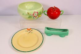 Clarice Cliff - Lot to include a a tomato form twin handled, covered pot, a Ravel pattern plate,