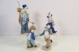 Four Nao clown figures / groups, largest approximately 29 cm (l),