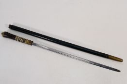 An antique sword stick with 36 cm (l) blade, horn and carved bone grip with lion mask pommel,