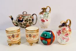 A pair of Royal Doulton jugs with floral decoration (restoration to one handle),
