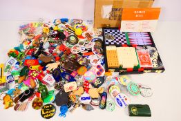 A good collection of pin badges, novelty keyrings and a boxed games compendium.