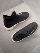 A pair of black and white trainer sock shoes,