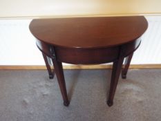 An early 20th century demi-lune mahogany hall table