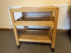 A contemporary light wood tea trolley