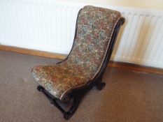 A 19th century nursing chair or slipper chair with floral patterned upholstered seat and backrest,