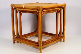 A nest of three bamboo side tables,
