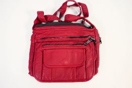 A Burgundy day handbag with nickel black detail and black lining with internal pockets.