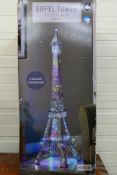 A large Eiffel Tower LED Floor Lamp in chrome with colour changing LED lights,