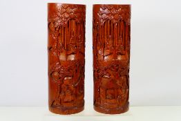 A pair of tall carved bamboo brush pots,