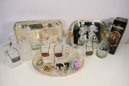 A collection of decanters with bottle labels, plated ware, empty Glenfiddich whisky tin and other.